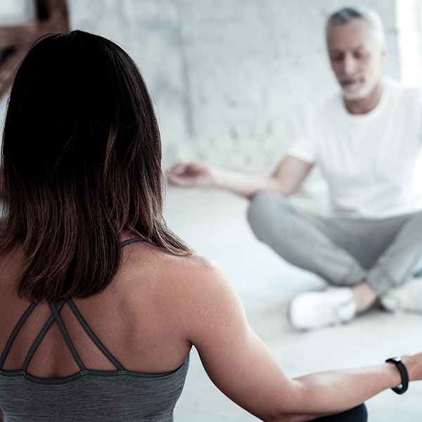 Young lady teaching yoga in class