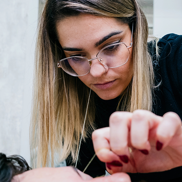 Female beautician doing male eyebrow hair removal